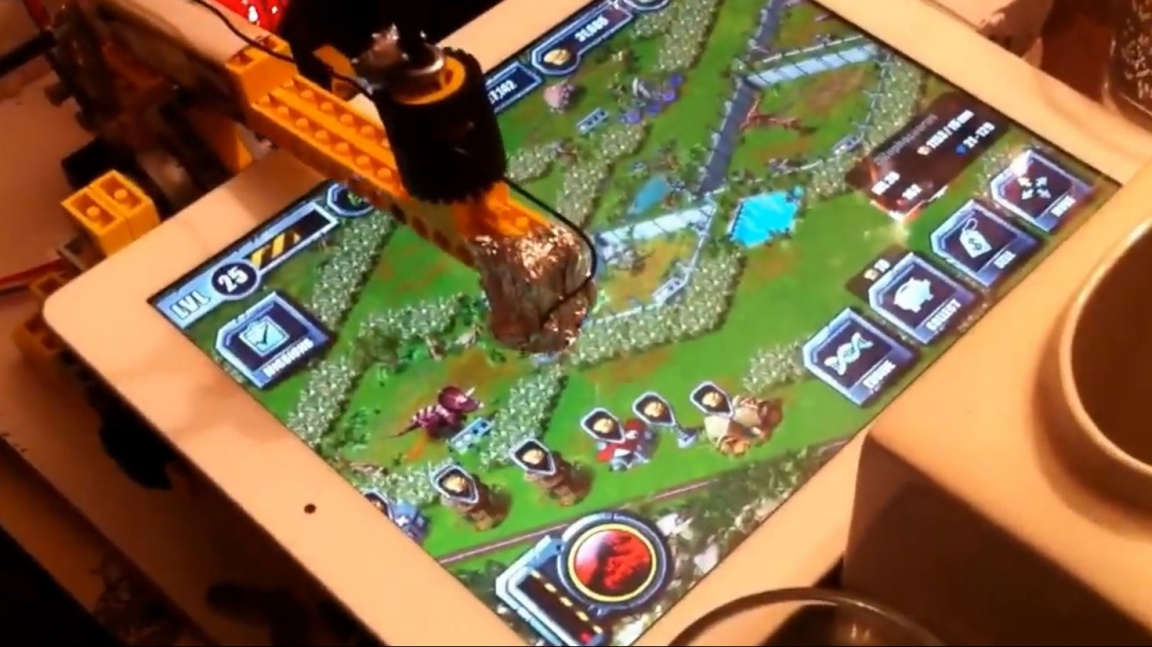 Robot z Lega hraje free to play hru na tabletu za svého majitele