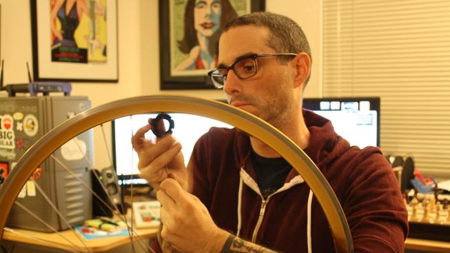 Josh_Sawyer_removing_spokes_from_a_bicycle_wheel