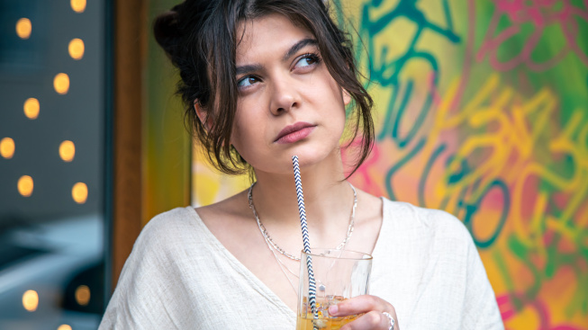 funny-young-woman-talking-phone-with-glass-lemonade