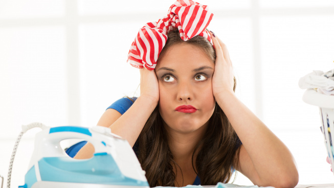 pensive-housewife-daydreaming-leaning-ironing-board-holding-her-head-front-her-are-iron-laundry-basket