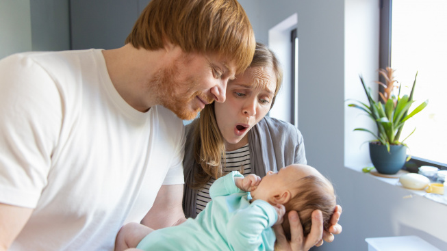 couple-new-parents-enjoying-cuddling-daughter