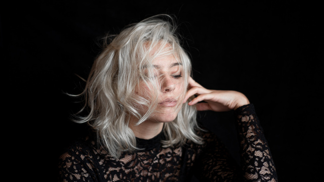 portrait-woman-against-black-background