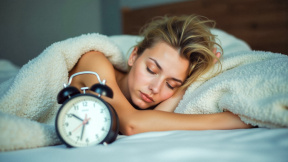 woman-peacefully-sleeping-bed-alarm-clock-calm-expression-early-morning-promoting-healthy-sleep-sleep-routine-stressfree-resting-wakeup-time