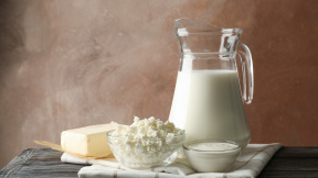 milk-cottage-cheese-butter-wooden-table-against-brown-background