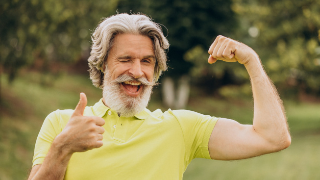 middle-aged-sportsman-pointing-his-biceps
