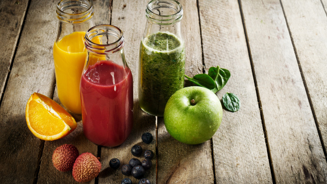 tasty-colorful-fresh-homemade-smoothies-glass-jars-wooden-table-healthy-detox-concept
