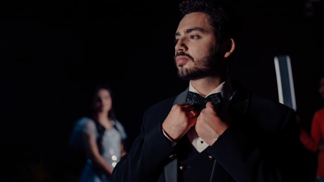 man-tuxedo-adjusts-his-bow-tie