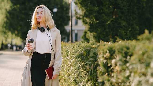 blonde-walks-summer-city-with-cup-coffee