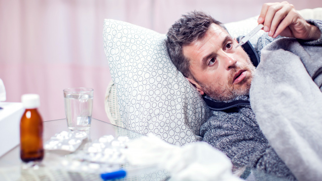 man-with-blue-scarf-got-flu-measuring-temperature-people-healthcare-medicine-concept