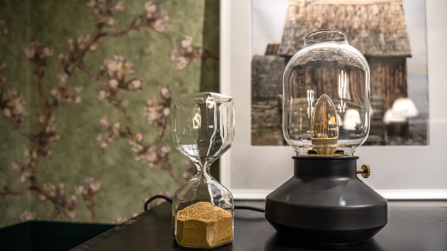 close-up-unusual-shaped-glass-hourglass-vintage-lamp-blurred-background